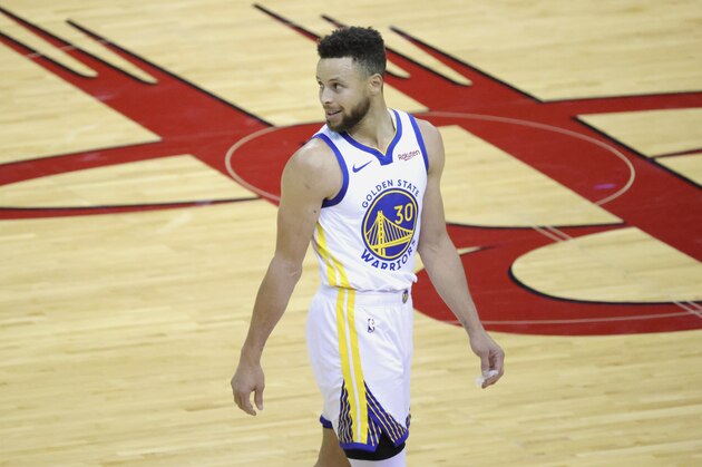 Golden State Warriors' Stephen Curry smiles while looking back during the third quarter against the Houston Rockets in an NBA basketball game Wednesday, March 17, 2021, in Houston. (Carmen Mandato/Pool Photo via AP)