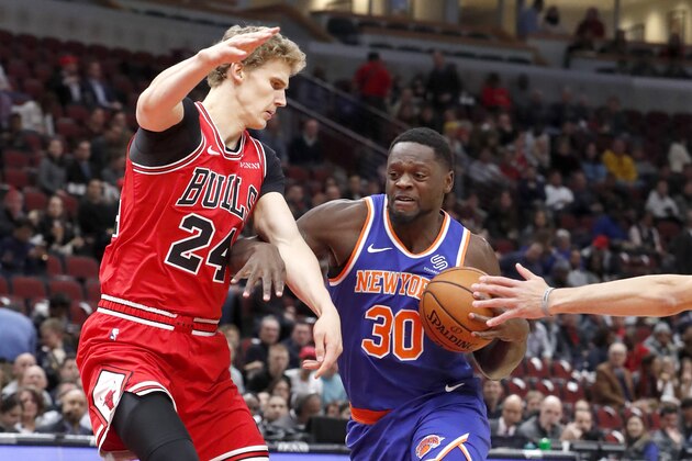 New York Knicks' Julius Randle (30) drives on Chicago Bulls' Lauri Markkanen during the first half of an NBA basketball game Tuesday, Nov. 12, 2019, in Chicago. (AP Photo/Charles Rex Arbogast)