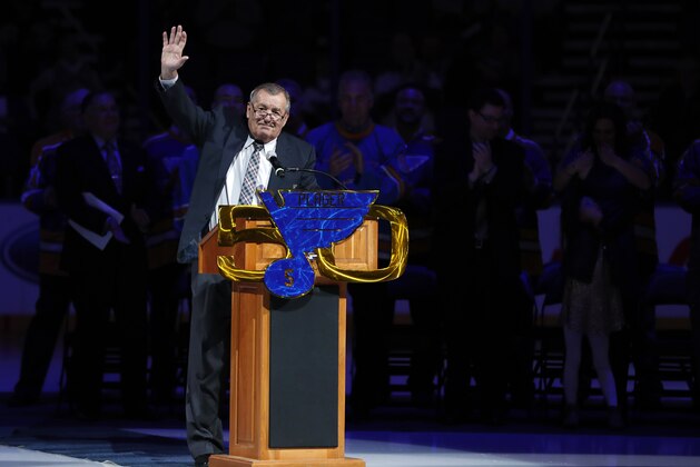 Former St. Louis Blues player Bob Plager waves to fans while speaking during a ceremony to retire his number before an NHL hockey game between the Blues and the Toronto Maple Leafs on Thursday, Feb. 2, 2017, in St. Louis. (AP Photo/Jeff Roberson)