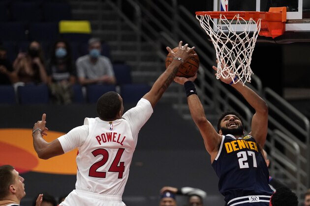 Toronto Raptors forward Norman Powell (24) blocks a shot by Denver Nuggets guard Jamal Murray (27) during the first half of an NBA basketball game Wednesday, March 24, 2021, in Tampa, Fla. (AP Photo/Chris O'Meara)