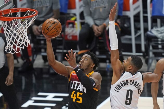 Utah Jazz guard Donovan Mitchell (45) goes to the basket as Brooklyn Nets guard Timothe Luwawu-Cabarrot (9) defends in the first half during an NBA basketball game Wednesday, March 24, 2021, in Salt Lake City. (AP Photo/Rick Bowmer)