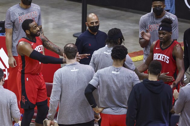 Houston Rockets guard John Wall, left, gestures during a timeout in the third quarter against the Charlotte Hornets in an NBA basketball game Wednesday, March 24, 2021, in Houston. (Troy Taormina/Pool Photo via AP)