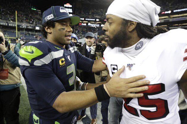 Seattle Seahawks quarterback Russell Wilson, left, talks with San Francisco 49ers cornerback Richard Sherman after an NFL football game, Sunday, Dec. 29, 2019, in Seattle. The 49ers won 26-21. (AP Photo/Ted S. Warren)