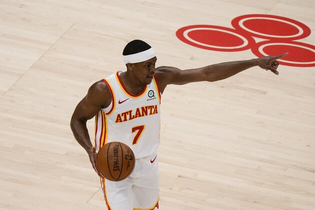 Atlanta Hawks' Rajon Rondo (7) points during the second half of an NBA basketball game against the Sacramento Kings on Saturday, March 13, 2021, in Atlanta. (AP Photo/Brynn Anderson)