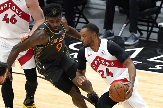 Toronto Raptors guard Norman Powell, right, drives against Chicago Bulls forward Patrick Williams during the first half of an NBA basketball game in Chicago, Sunday, March 14, 2021. (AP Photo/Nam Y. Huh)