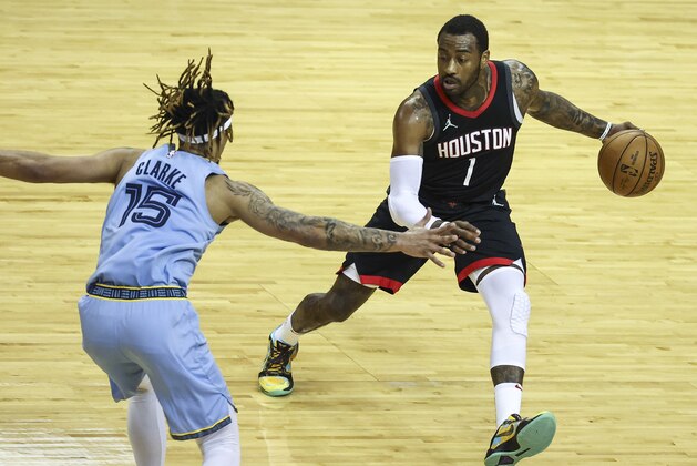 Houston Rockets guard John Wall (1) dribbles the ball as Memphis Grizzlies forward Brandon Clarke (15) defends during the first quarter of an NBA basketball game in Houston, Sunday, Feb. 28, 2021. (Troy Taormina/Pool Photo via AP)