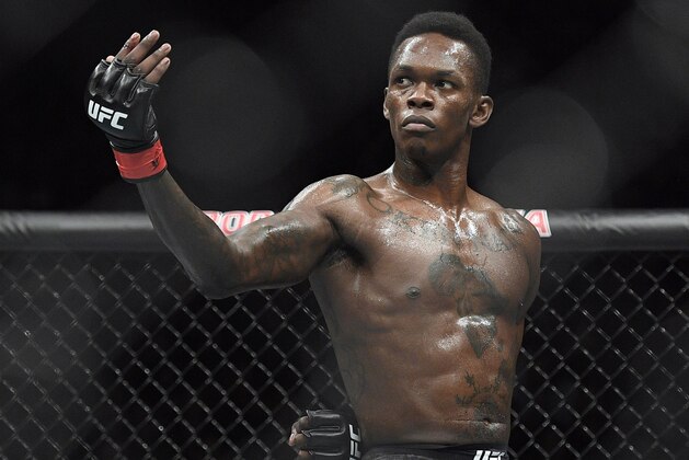 FILE - In this Feb. 10, 2019, file photo, Nigeria's Israel Adesanya poses as he fights Brazil's Anderson Silva in their middleweight bout at the UFC 234 mixed martial arts fights in Melbourne, Australia. Adesanya challenges champion Jan Blachowicz of Poland for the light heavyweight title in the main event of UFC 259 on Saturday in Las Vegas.  (AP Photo/Andy Brownbill, File)