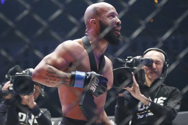 Mixed martial arts (MMA) fighters Demetrious Johnson of the United States celebrates after defeating Japan's Yuya Wakamatsu during their flyweight world grand prix quarterfinal of One Championship bout in Tokyo, Sunday, March 31, 2019. (AP Photo/Koji Sasahara)