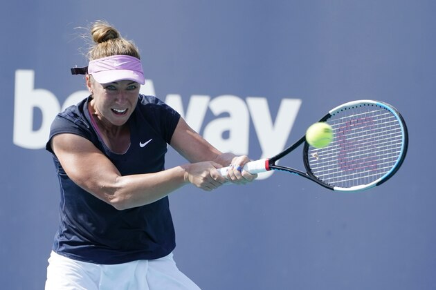 Kristina Kucova, of Slovenia, returns to Ashleigh Barty, of Australia, during the Miami Open tennis tournament, Thursday, March 25, 2021, in Miami Gardens, Fla. (AP Photo/Marta Lavandier)