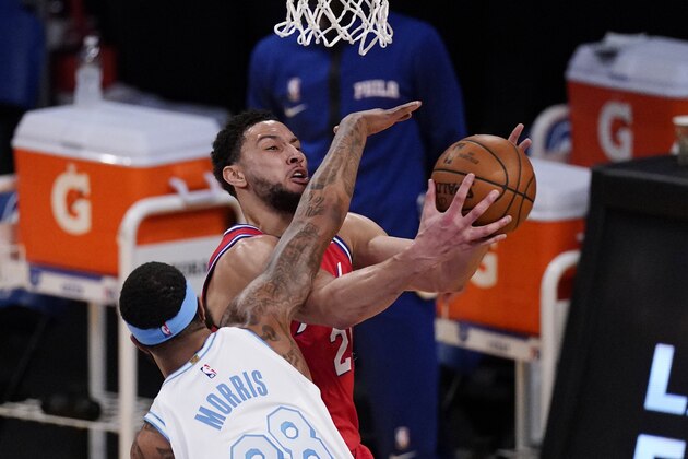 Philadelphia 76ers guard Ben Simmons, top, shoots as Los Angeles Lakers forward Markieff Morris defends during the first half of an NBA basketball game Thursday, March 25, 2021, in Los Angeles. (AP Photo/Mark J. Terrill)