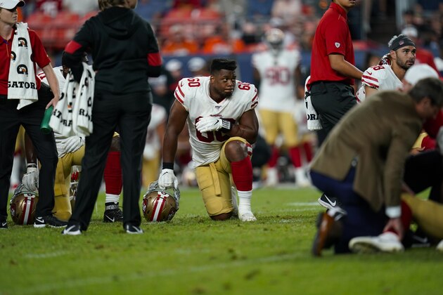 San Francisco 49ers defensive tackle Kevin Givens takes a knee while a teammate is injured son the field during an NFL preseason football game between the Denver Broncos and the San Francisco 49ers, Monday, Aug. 19, 2019, in Denver. (AP Photo/Jack Dempsey)
