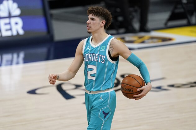 Charlotte Hornets guard LaMelo Ball looks to pass the ball against the Denver Nuggets in the second half of an NBA basketball game Wednesday, March 17, 2021, in Denver. (AP Photo/David Zalubowski)