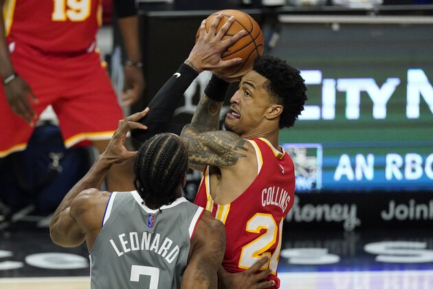 Atlanta Hawks forward John Collins, tries to pass while under pressure from Los Angeles Clippers forward Kawhi Leonard during the second half of an NBA basketball game Monday, March 22, 2021, in Los Angeles. The Clippers won 119-110. (AP Photo/Mark J. Terrill)