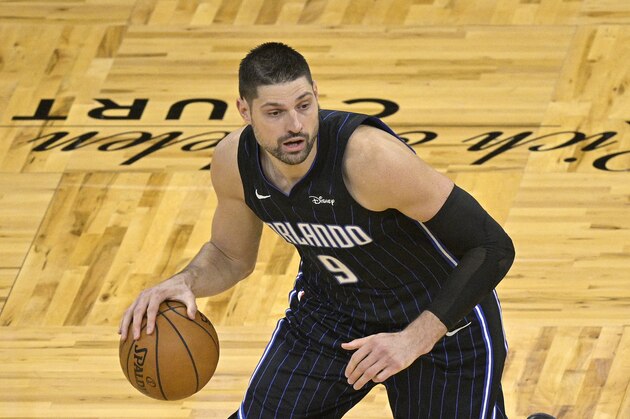 Orlando Magic center Nikola Vucevic (9) sets up a play during the second half of an NBA basketball game against the Miami Heat on Sunday, March 14, 2021, in Orlando, Fla. (AP Photo/Phelan M. Ebenhack)