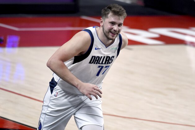 Dallas Mavericks guard Luka Doncic smiles after hitting a 3-point shot during the second half of an NBA basketball game against the Portland Trail Blazers in Portland, Ore., Sunday, March 21, 2021. Doncic scored 37 points as the Mavericks won the game 132-92. (AP Photo/Steve Dykes) Dallas Mavericks guard Luka Doncic smiles after hitting a 3-point shot during the second half of an NBA basketball game against the Portland Trail Blazers in Portland, Ore., Sunday, March 21, 2021. Doncic scored 37 points as the Mavericks won the game 132-92. (AP Photo/Steve Dykes)