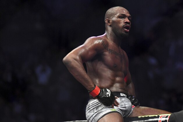 Jon Jones goes up on top of the octagon after defeating Alexander Gustafsson in the UFC men's light heavyweight mixed martial arts bout at UFC 232, Saturday, Dec. 29, 2018, in Inglewood, Calif. (AP Photo/Kyusung Gong)