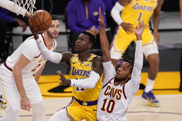 Los Angeles Lakers guard Dennis Schroder, center, shoots as Cleveland Cavaliers guard Darius Garland, right, defends and forward Larry Nance Jr. watches during the first half of an NBA basketball game Friday, March 26, 2021, in Los Angeles. (AP Photo/Mark J. Terrill)