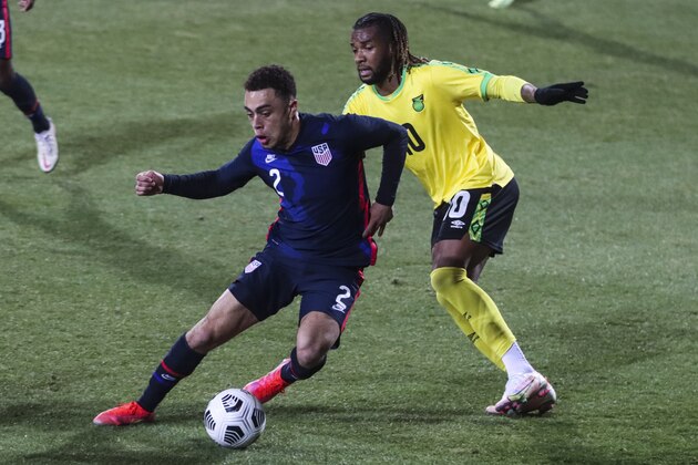 USA's Sergino Dest, left, duels for the ball with Jamaica's Kasey Palmer during the international friendly soccer match between USA and Jamaica at SC Wiener Neustadt stadium in Wiener Neustadt, Austria, Thursday, March 25, 2021. (AP Photo/Ronald Zak)