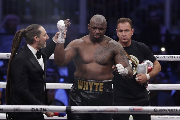 Dillian Whyte of Britain celebrates winning against Mariusz Wach of Poland fight during a heavyweight undercard boxing match at the Diriyah Arena, in Riyadh, Saudi Arabia, Saturday, Dec. 7, 2019. (AP Photo/Hassan Ammar)