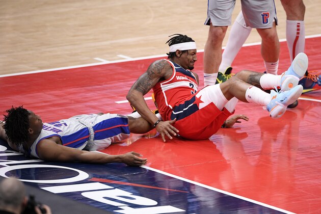 Washington Wizards guard Bradley Beal (3) reacts after he fell to the floor and being called for a foul against Detroit Pistons guard Saben Lee, left, during the first half of an NBA basketball game Saturday, March 27, 2021, in Washington. (AP Photo/Nick Wass)