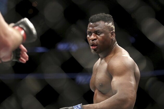 Francis Ngannou in action against Stipe Miocic during a heavyweight championship mixed martial arts bout at UFC 220, Sunday, Jan. 21, 2018, in Boston. Miocic retained his title via unanimous decision. (AP Photo/Gregory Payan)