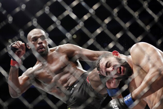 Jon Jones, left, and Dominick Reyes, right, during a light heavyweight mixed martial arts bout at UFC 247 Saturday, Feb. 8, 2020, in Houston. (AP Photo/Michael Wyke)