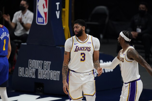 Los Angeles Lakers forward Anthony Davis (3) and Los Angeles Lakers guard Kentavious Caldwell-Pope (1) in the first half of an NBA basketball game Sunday, Feb. 14, 2021, in Denver. (AP Photo/David Zalubowski)