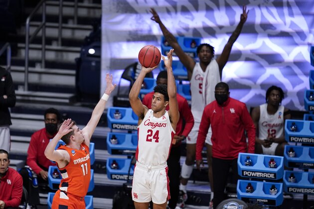 Houston guard Quentin Grimes (24) shoots on Syracuse guard Joseph Girard III (11) in the second half of a Sweet 16 game in the NCAA men's college basketball tournament at Hinkle Fieldhouse in Indianapolis, Saturday, March 27, 2021. (AP Photo/Michael Conroy)