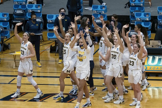 Michigan players waive to their fans after a win over Florida Gulf Coast in the first round of the women's NCAA tournament at the University of Texas San Antonio Convocation Center in San Antonio, Texas, Sunday March 21, 2021. Michigan won 87-66. (AP Photo/Michael Thomas)