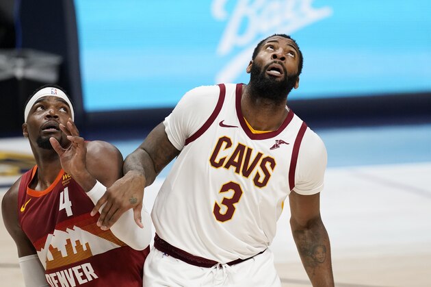 Denver Nuggets forward Paul Millsap, left, fights for position for a rebound with Cleveland Cavaliers center Andre Drummond in the second half of an NBA basketball game Wednesday, Feb. 10, 2021, in Denver. (AP Photo/David Zalubowski)