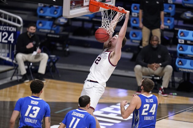 Gonzaga forward Drew Timme (2) dunks as Christian Bishop (13), Marcus Zegarowski (11) and Creighton guard Mitch Ballock (24) look on in the second half of a Sweet 16 game in the NCAA men's college basketball tournament at Hinkle Fieldhouse in Indianapolis, Sunday, March 28, 2021. (AP Photo/Michael Conroy)