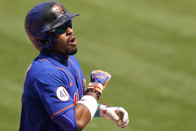 New York Mets' Francisco Lindor (12) reacts after scoring god a solo home run during the fifth inning of a spring training baseball game against the Miami Marlins, Tuesday, March 23, 2021, in Port St. Lucie, Fla. (AP Photo/Lynne Sladky)