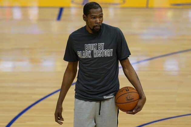 Brooklyn Nets forward Kevin Durant wears a Black History Month shirt as he warms up before an NBA basketball game against the Golden State Warriors in San Francisco, Saturday, Feb. 13, 2021. (AP Photo/Jeff Chiu)