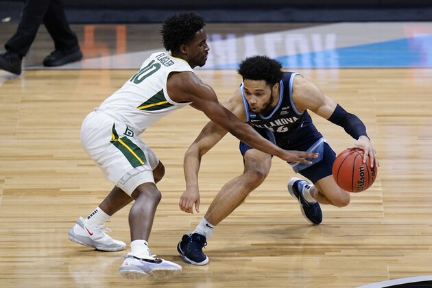 Villanova guard Caleb Daniels (14) protects the ball from Baylor guard Adam Flagler (10) in the second half of a Sweet 16 game in the NCAA men's college basketball tournament at Hinkle Fieldhouse in Indianapolis, Saturday, March 27, 2021. (AP Photo/AJ Mast)