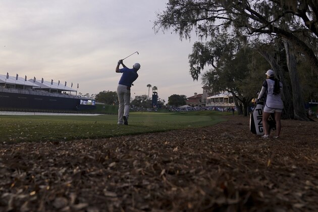 Lee Westwood, of England, hits from the rough on the 18th hole during the third round of The Players Championship golf tournament Saturday, March 13, 2021, in Ponte Vedra Beach, Fla. (AP Photo/Gerald Herbert)