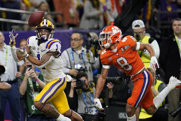 FILE - In this Jan. 13, 2020, file photo, LSU wide receiver Ja'Marr Chase catches a touchdown pass in front of Clemson cornerback A.J. Terrell during the first half of a NCAA College Football Playoff national championship game in New Orleans. All-America wide receiver Chase, cornerback Kary Vincent Jr. and defensive end Neil Farrell Jr. have announced they wonâ€™t be playing this season. (AP Photo/David J. Phillip, File)