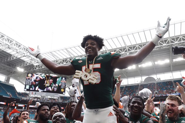 FILE - In this Sept. 21, 2019, file photo, Miami defensive lineman Gregory Rousseau (15) celebrates a turnover and wears the turnover chain during the first half of an NCAA college football game against Central Michigan, in Miami Gardens, Fla. Rousseau was selected to The Associated Press All-Atlantic Coast Conference football team, Tuesday, Dec. 10, 2019. (AP Photo/Brynn Anderson, File)