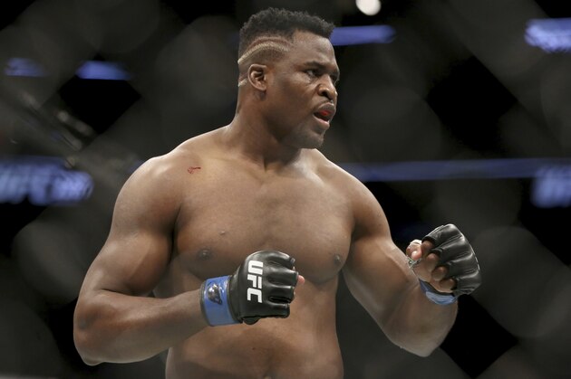 Francis Ngannou in action against Stipe Miocic during a heavyweight championship mixed martial arts bout at UFC 220, Sunday, Jan. 21, 2018, in Boston. Miocic retained his title via unanimous decision. (AP Photo/Gregory Payan)