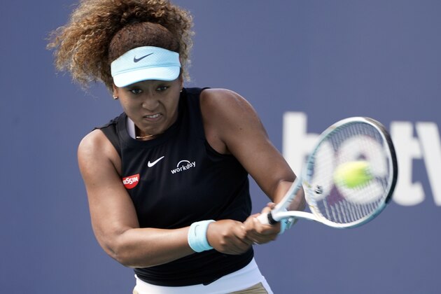 Naomi Osaka, of Japan, returns to Elise Mertens, of Beligium, during the Miami Open tennis tournament, Monday, March 29, 2021, in Miami Gardens, Fla. (AP Photo/Marta Lavandier)