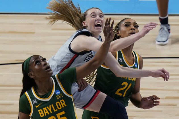 UConn guard Paige Bueckers, center, drives to the basket between Baylor defenders Queen Egbo (25) and DiJonai Carrington (21) during the first half of a college basketball game in the Elite Eight round of the women's NCAA tournament at the Alamodome in San Antonio, Monday, March 29, 2021. (AP Photo/Eric Gay)