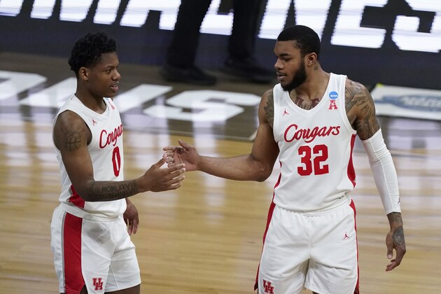 Houston guard Marcus Sasser (0) and Houston forward Reggie Chaney (32) react to a play against Oregon State during the second half of an Elite 8 game in the NCAA men's college basketball tournament at Lucas Oil Stadium, Monday, March 29, 2021, in Indianapolis. (AP Photo/Michael Conroy)