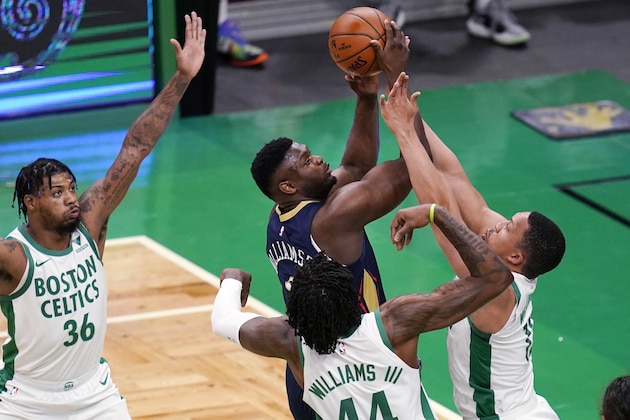 New Orleans Pelicans forward Zion Williamson, center, drives to the basket against the Boston Celtics during the first half of an NBA basketball game, Monday, March 29, 2021, in Boston. From left defending Williamson are Celtics' Marcus Smart, Robert Williams III, and Grant Williams. (AP Photo/Charles Krupa)