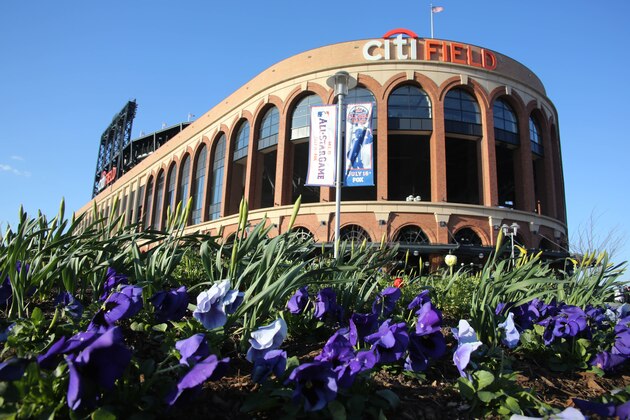 Flowers flutter in a strong breeze outside Citi Field before a baseball game between the New York Mets and San Diego Padres on Wednesday, April 3, 2013, in New York.  (AP Photo/Peter Morgan)