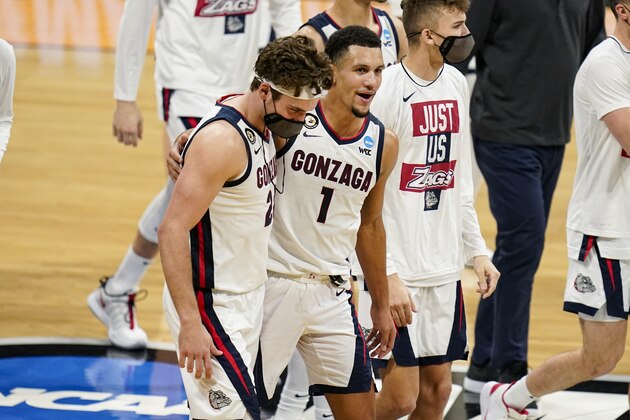 Gonzaga guard Jalen Suggs (1) and forward Corey Kispert (24) walk off the court at half time of a second-round game against Oklahoma in the NCAA men's college basketball tournament at Hinkle Fieldhouse in Indianapolis, Monday, March 22, 2021. (AP Photo/Michael Conroy)