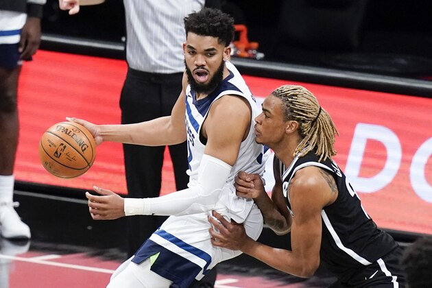 Brooklyn Nets' Nicolas Claxton, right, defends Minnesota Timberwolves' Karl-Anthony Towns during the first half of an NBA basketball game Monday, March 29, 2021, in New York. (AP Photo/Frank Franklin II)