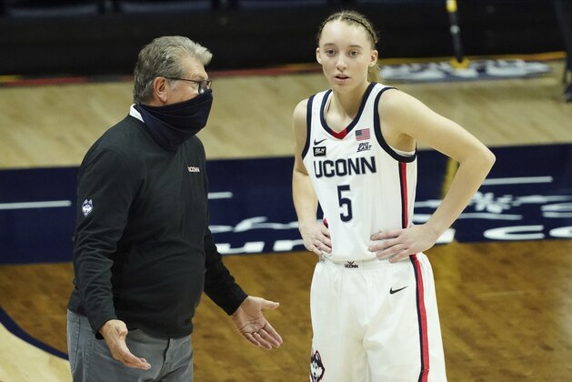 Connecticut head coach Geno Auriemma talks with guard Paige Bueckers (5) during a break in the first half of an NCAA college basketball game against UMass-Lowell, Saturday, Dec. 12, 2020, in Storrs, Conn. (David Butler II/Pool Photo via AP)