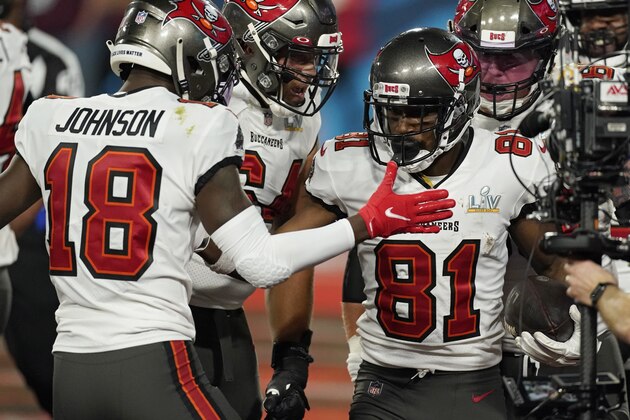 Tampa Bay Buccaneers wide receiver Tyler Johnson, left, celebrates after wide receiver Antonio Brown, right, scored a touchdown against the Kansas City Chiefs during the first half of the NFL Super Bowl 55 football game Sunday, Feb. 7, 2021, in Tampa, Fla. (AP Photo/Ashley Landis)