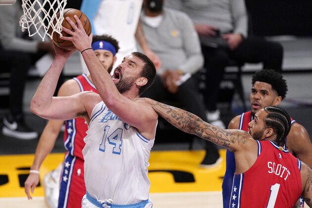 Los Angeles Lakers center Marc Gasol, left, is fouled by Philadelphia 76ers forward Mike Scott as he shoots during the first half of an NBA basketball game Thursday, March 25, 2021, in Los Angeles. (AP Photo/Mark J. Terrill)