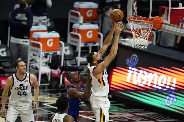 Utah Jazz center Rudy Gobert grabs a rebound against the Los Angeles Clippers during the first half of an NBA basketball game Wednesday, Feb. 17, 2021, in Los Angeles. (AP Photo/Marcio Jose Sanchez)
