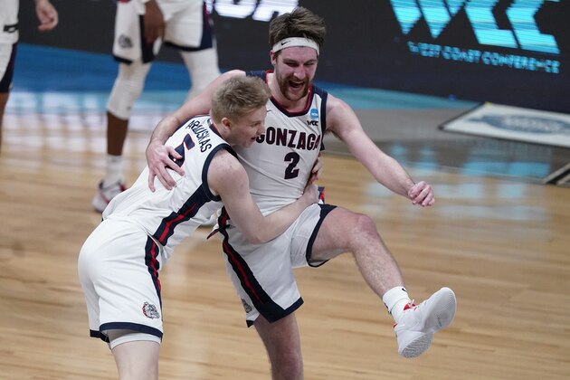 Gonzaga forward Drew Timme (2) celebrates with Gonzaga guard Martynas Arlauskas (5) after an Elite 8 game against Southern California in the NCAA men's college basketball tournament at Lucas Oil Stadium, Tuesday, March 30, 2021, in Indianapolis. Gonzaga won 85-66. (AP Photo/Michael Conroy)